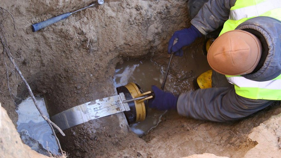 Worker repairing sewer line